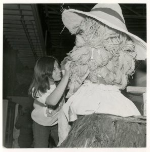 A student works on the hair of the girl in the 1974 float “Happiness Is Finding A Friend.”