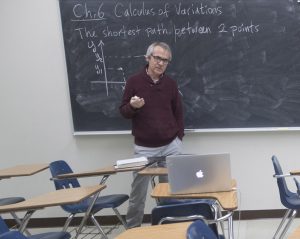 Physics Professor teaching virtually in a classroom