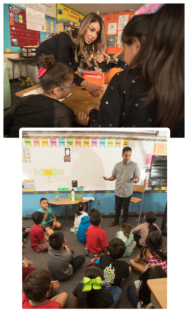 Two alumni working with elementary school kids in the classrooms
